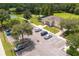 Aerial view of a community clubhouse featuring tennis courts, a pool and park area, and convenient parking at 25323 Lexington Oaks Blvd, Wesley Chapel, FL 33544