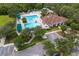 Aerial view of a luxurious community pool with ample seating, surrounded by green spaces at 25323 Lexington Oaks Blvd, Wesley Chapel, FL 33544