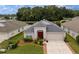 Beautiful single-story home features a well-manicured lawn and lovely landscaping at 25323 Lexington Oaks Blvd, Wesley Chapel, FL 33544