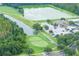 Aerial view featuring community golf course, clubhouse, and water feature, providing a relaxing atmosphere at 25323 Lexington Oaks Blvd, Wesley Chapel, FL 33544