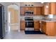 Eat-in kitchen equipped with stainless steel appliances, wooden cabinets, and granite countertops at 25323 Lexington Oaks Blvd, Wesley Chapel, FL 33544