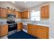 Functional kitchen with light wood cabinets, granite countertops, and stainless steel appliances at 25323 Lexington Oaks Blvd, Wesley Chapel, FL 33544