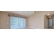 Bright living room with vaulted ceiling, ceiling fan, and sliding glass door leading to the outside at 25323 Lexington Oaks Blvd, Wesley Chapel, FL 33544