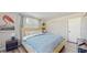 Bright bedroom with blue walls, a large bed, and modern decor accents at 2572 Forest Run Ct, Clearwater, FL 33761