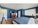 Cozy bedroom with an accent rug, large closet, and dark blue accent wall at 2572 Forest Run Ct, Clearwater, FL 33761