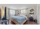 Inviting bedroom with a cozy bed, large windows, and artwork in the background at 2572 Forest Run Ct, Clearwater, FL 33761