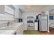 Efficient kitchen with white cabinets, stainless steel appliances, and ample counter space at 2572 Forest Run Ct, Clearwater, FL 33761
