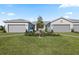 Charming exterior of paired homes, each featuring a two-car garage and well-manicured lawn at 25969 Bimini Sands Ct, Englewood, FL 34223