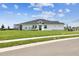 Spacious backyard features lush lawn and views of the home's rear elevation at 2832 Marrakesh Ln, Sarasota, FL 34234