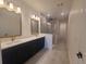 Well-lit bathroom with double vanity, modern fixtures, glass-enclosed shower, and neutral color scheme at 2832 Marrakesh Ln, Sarasota, FL 34234