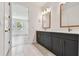 Elegant bathroom featuring dual vanity, white countertop, and views of a bedroom at 2832 Marrakesh Ln, Sarasota, FL 34234