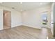 Bedroom featuring light floors, neutral paint and a glass panel exterior door at 2832 Marrakesh Ln, Sarasota, FL 34234