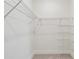 Spacious walk-in closet with carpet and wire shelving for convenient storage at 2832 Marrakesh Ln, Sarasota, FL 34234