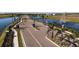 Community entrance featuring a gate, palm trees, lush landscaping, and a fountain at 2832 Marrakesh Ln, Sarasota, FL 34234