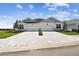Charming home featuring a large driveway, well-manicured lawn, and beautiful architectural details at 2832 Marrakesh Ln, Sarasota, FL 34234