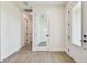 Hallway with plank flooring, white walls, white doors and black hardware at 2832 Marrakesh Ln, Sarasota, FL 34234