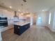 Modern kitchen featuring a large island, stainless steel appliances, and white cabinets with contemporary pendant lights at 2832 Marrakesh Ln, Sarasota, FL 34234