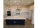 Bright kitchen with modern stainless steel appliances, large island and pendant lighting at 2832 Marrakesh Ln, Sarasota, FL 34234