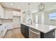 Bright kitchen with a navy island, stainless steel appliances, and a white countertop at 2832 Marrakesh Ln, Sarasota, FL 34234