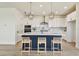 Bright kitchen features a center island with counter seating, white cabinetry, and modern pendant lighting at 2832 Marrakesh Ln, Sarasota, FL 34234