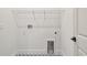 Laundry room with modern tile flooring, hookups, and convenient access at 2832 Marrakesh Ln, Sarasota, FL 34234