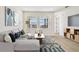 Comfortable living room is styled with contemporary furniture, modern art, and large windows overlooking the lanai at 2832 Marrakesh Ln, Sarasota, FL 34234