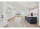 Open-concept living space adjacent to a kitchen with wood floors and natural light at 2832 Marrakesh Ln, Sarasota, FL 34234