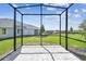 Screened-in patio with pavers, perfect for enjoying the outdoors with backyard views at 2832 Marrakesh Ln, Sarasota, FL 34234
