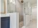 Modern glass shower with rainfall shower head and white tile in an elegant bathroom at 2832 Marrakesh Ln, Sarasota, FL 34234