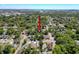 An aerial view of a home and surrounding neighborhood with mature trees and lush landscaping at 3106 E 25Th Ave, Tampa, FL 33605
