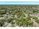 An aerial view of a home and surrounding neighborhood with mature trees and lush landscaping at 3106 E 25Th Ave, Tampa, FL 33605