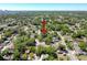 An aerial view of a home and surrounding neighborhood with mature trees and lush landscaping at 3106 E 25Th Ave, Tampa, FL 33605