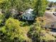 Aerial shot of house with overgrown landscape needing maintenance, showcasing the property's potential at 3106 E 25Th Ave, Tampa, FL 33605