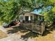 Exterior showcases a wraparound deck and a mature tree providing plenty of shade at 3106 E 25Th Ave, Tampa, FL 33605