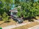 Exterior showcasing mature trees and a well-lit walkway, enhancing the curb appeal at 3106 E 25Th Ave, Tampa, FL 33605
