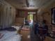 Cluttered room with boxes and items obstructing view of door, awaiting renovation or clearing at 3106 E 25Th Ave, Tampa, FL 33605