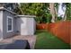 Turf backyard with a privacy fence and an outdoor water hose at 314 E Althea Ave, Tampa, FL 33612