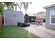 Backyard with a large shed, table and chairs for entertaining at 314 E Althea Ave, Tampa, FL 33612
