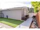 Backyard featuring a small grass area, walkway, fence and motorcycle at 314 E Althea Ave, Tampa, FL 33612