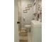 View of a half bathroom featuring decorative signs, modern fixtures, a toilet, and a white vanity with storage at 314 E Althea Ave, Tampa, FL 33612