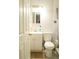 A white bathroom with a toilet and vanity, and a shower at 314 E Althea Ave, Tampa, FL 33612