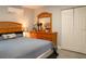 View of a bedroom featuring a Queen bed, wood dresser, and double door closet at 314 E Althea Ave, Tampa, FL 33612