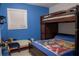 This is a bedroom with blue walls and a bunk bed and a toddler bed at 314 E Althea Ave, Tampa, FL 33612