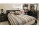 Cozy bedroom with a patterned quilt on the bed and dark furniture, creating a serene space at 314 E Althea Ave, Tampa, FL 33612