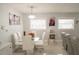 Bright dining room with a glass table, white chairs, modern lighting, and decor at 314 E Althea Ave, Tampa, FL 33612