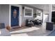 Inviting front porch with a blue door, two chairs, and decorative accents for a welcoming atmosphere at 314 E Althea Ave, Tampa, FL 33612