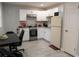 This is a view of the kitchen, which has white cabinets, gray floors and stainless steel appliances at 314 E Althea Ave, Tampa, FL 33612