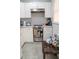 Well-lit kitchen featuring white cabinets, stainless steel stove, and tiled backsplash at 314 E Althea Ave, Tampa, FL 33612