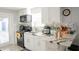 Bright kitchen featuring white cabinets, modern appliances, and a breakfast bar, perfect for casual dining at 314 E Althea Ave, Tampa, FL 33612