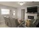 Cozy living room with a fireplace, TV, reclining seating and decor at 314 E Althea Ave, Tampa, FL 33612